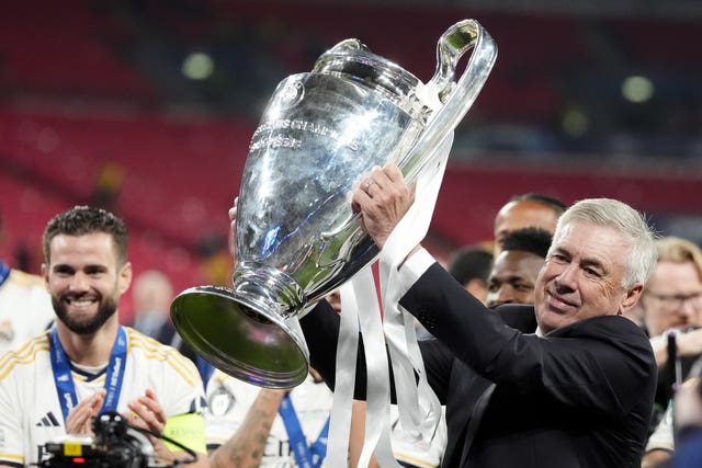 Real Madrid manager Carlo Ancelotti celebrates with the Champions League trophy