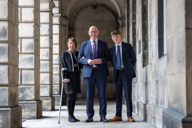 John Swinney with his wife and son outside the Court of Session