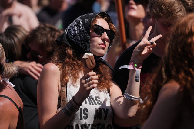 A woman in the crowd with an ice cream