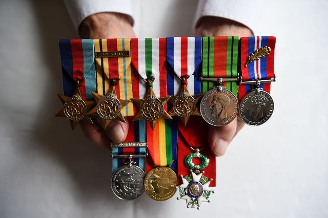 Don Sheppard holds his medals