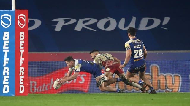 Jack Welsby, left, scores St Helens' winning try