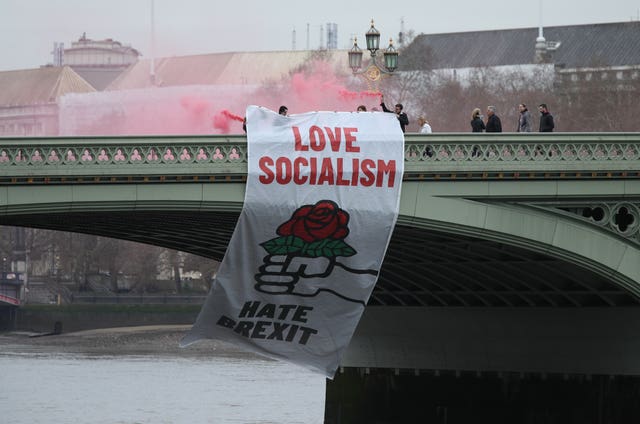 An anti-Brexit banner is unfurled from Westminster Bridge on a day of protest (Yui Mok/PA)