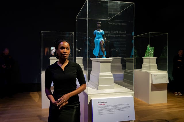 Tschabalala Self standing next to her bronze Lady In Blue