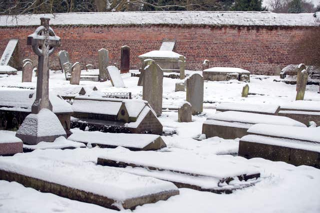 Gravestones covered in snow in Berkshire (Steve Parsons/PA)