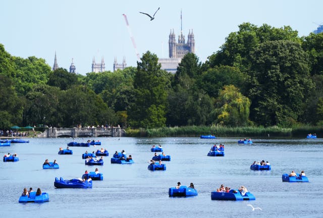 People on pedaloes on a lake