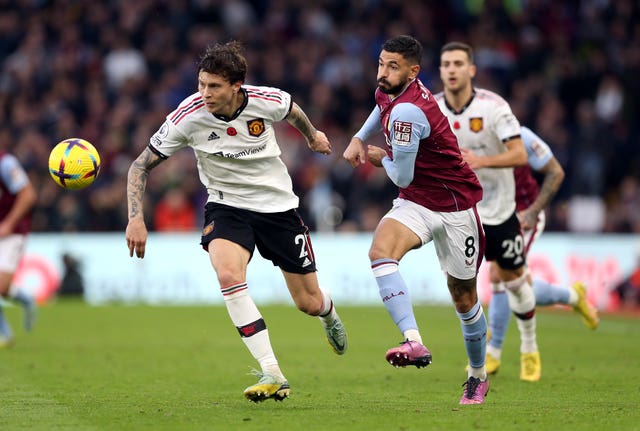 Manchester United’s Victor Lindelof and Aston Villa’s Morgan Sanson (right) battle for the ball