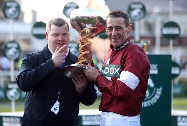 Gordon Elliott and jockey Davy Russell celebrate Tiger Roll's Aintree triumph