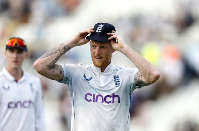 Ben Stokes holds his England cap as he leaves the field of play.