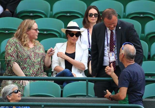 A man believed to be a royal bodyguard speaking to Mr Hasanov (Mike Egerton/PA)
