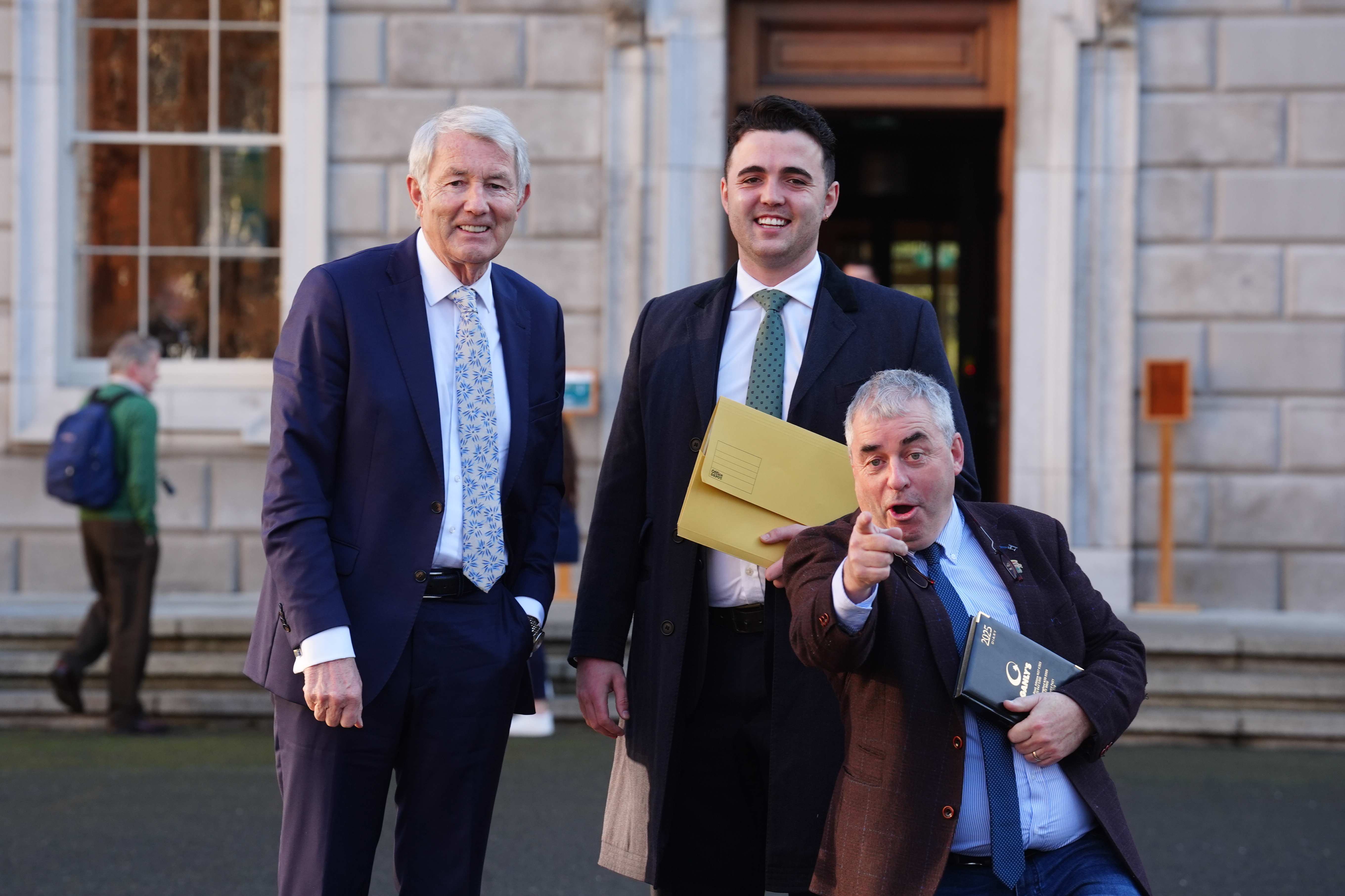  of Regional Independent Group (left to right) Michael Lowry, Barry Heneghan and Kevin ‘Boxer’ Moran at Leinster House in Dublin, after a deal was reached to form Ireland’s next government