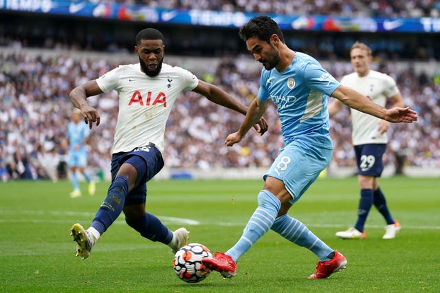 Japhet Tanganga (left) challenges Manchester City's Ilkay Gundogan 