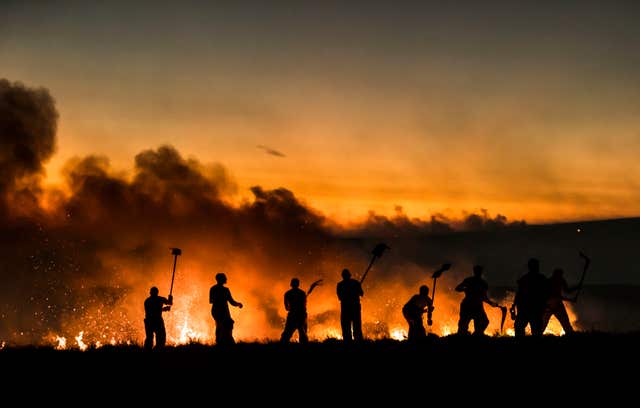 Firefighters tackle a wildfire on Winter Hill in June 2018