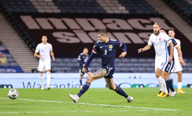 Scotland's Lyndon Dykes scores his side's first goal against Slovakia