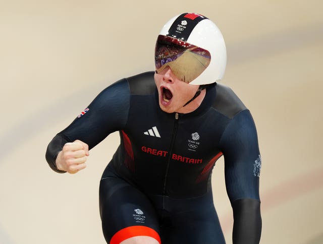 Jack Carlin celebrates with a fist punch after helping Great Britain post the second fastest time in qualifying for the men's team sprint.