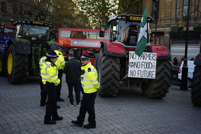 Police officers speaking to farmers taking part in the protest