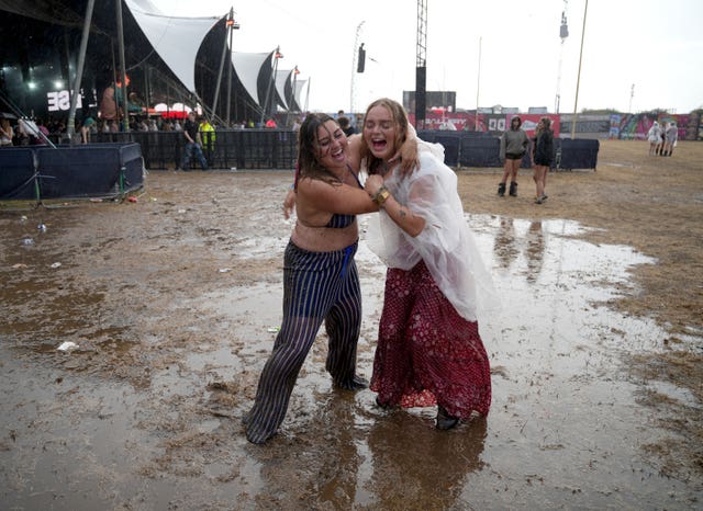 Women hug in the mud at Reading Festival 2026