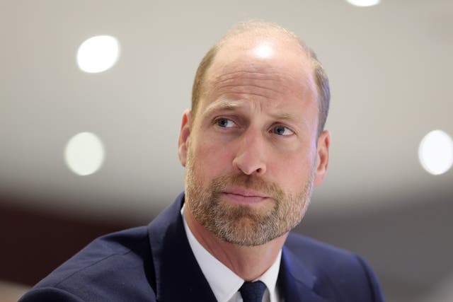 The Prince of Wales listens to a speaker during a visit to Cardiff