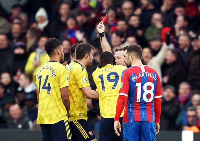 Referee Paul Tierney shows Pierre-Emerick Aubameyang (left) a red card following a VAR review