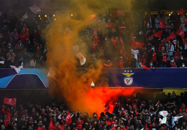 Benfica fans set off a flare in the stand