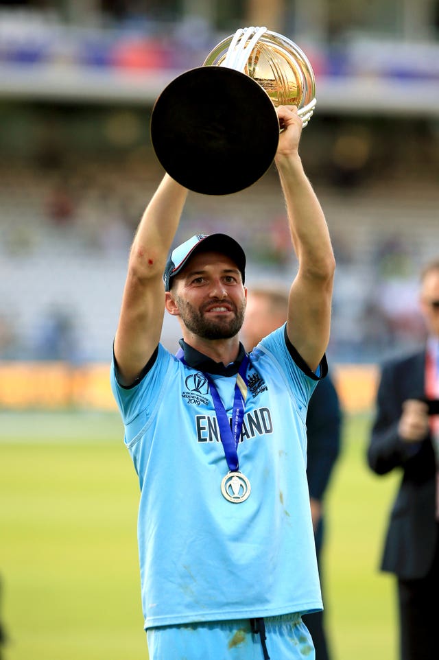 Mark Wood lifts the World Cup trophy.