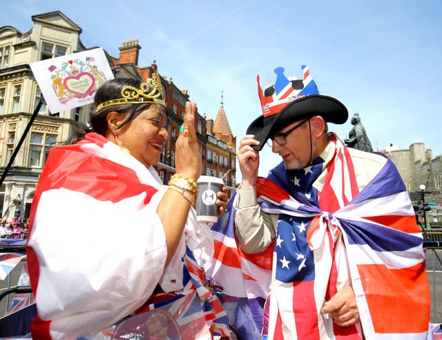 Pleased to meet you: Royal fans greet each other as they take their positions outside Windsor Castle (Gareth Fuller/PA)