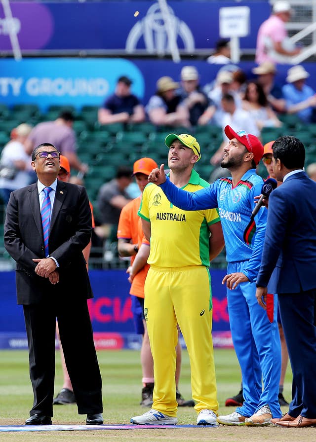 Australia captain Aaron Finch, centre, at the coin toss against Afghanistan