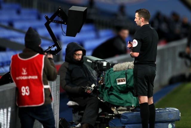 Referee Michael Oliver checks the VAR pitchside monitor at Crystal Palace