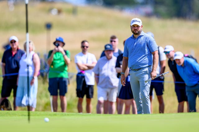 England's Jordan Smith watches his ball roll towards the flag