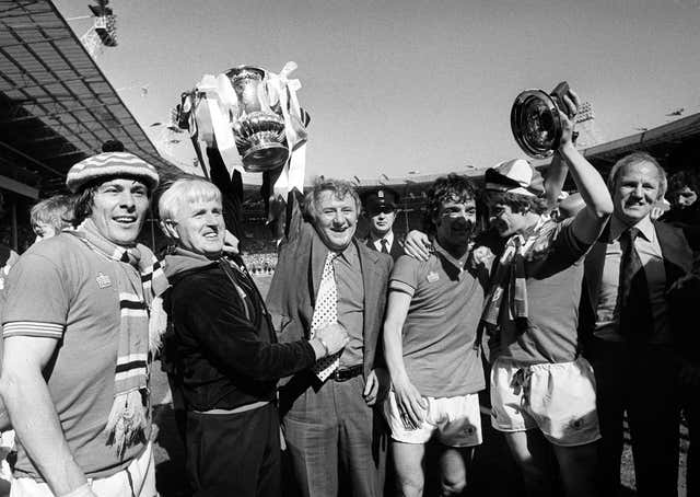 Tommy Docherty celebrates winning the 1977 FA Cup with Manchester United
