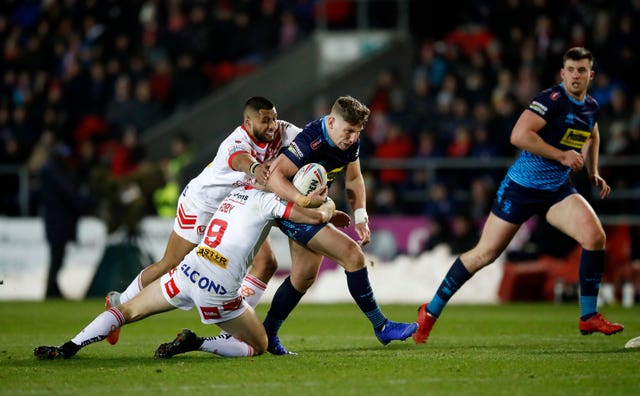 St Helens’ Dominique Peyroux and James Roby hold up Wigan