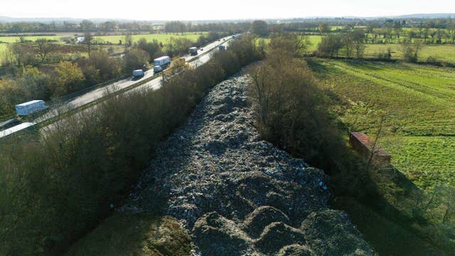 The mountain of waste stretching into the distance with the A34 running alongside on the left and green fields on the right