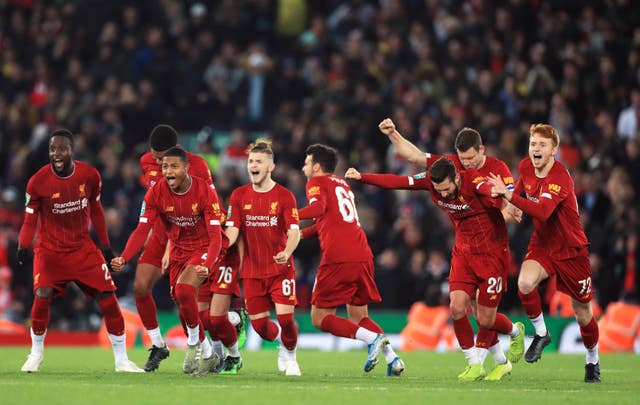 Liverpool players celebrate winning the penalty shootout against Arsenal