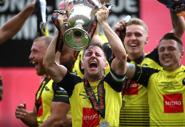 Harrogate Town captain Josh Falkingham lifts the National League play-off trophy at Wembley