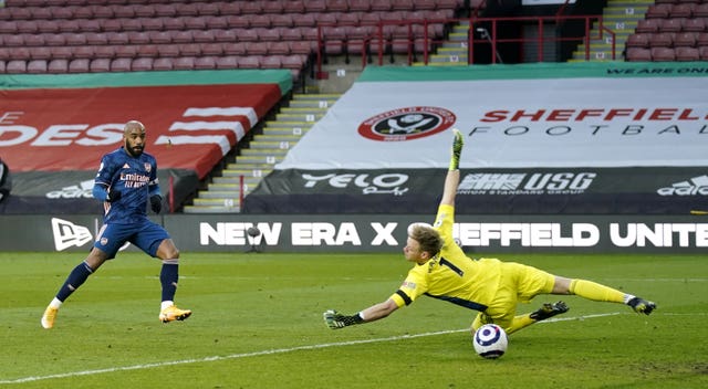 Alexandre Lacazette, left, beats Aaron Ramsdale to open the scoring