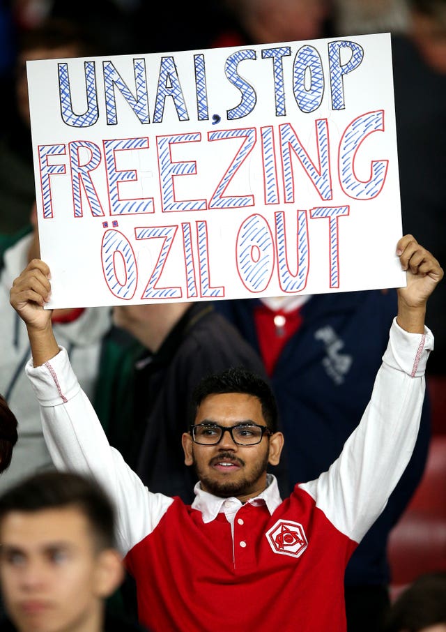 An Arsenal fan shows his support for Mesut Ozil