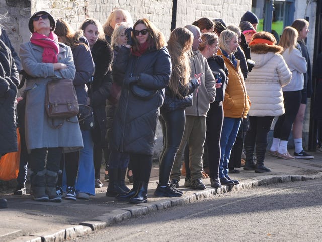 Members of the public line the route to the church