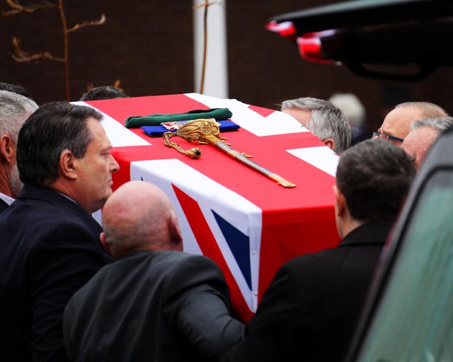 Surgeon Captain Rick Jolly's coffin dressed with the Union flag, his medals, sword and green beret (LPhot Ken Gaunt/Royal Navy/MoD/Crown copyright/PA)