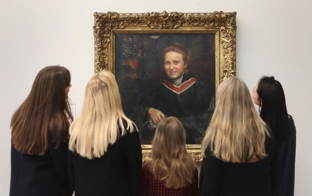 Tate Britain staff look at Annie Swynnerton's portrait of suffragist Millicent Fawcett (Philip Toscano/PA)