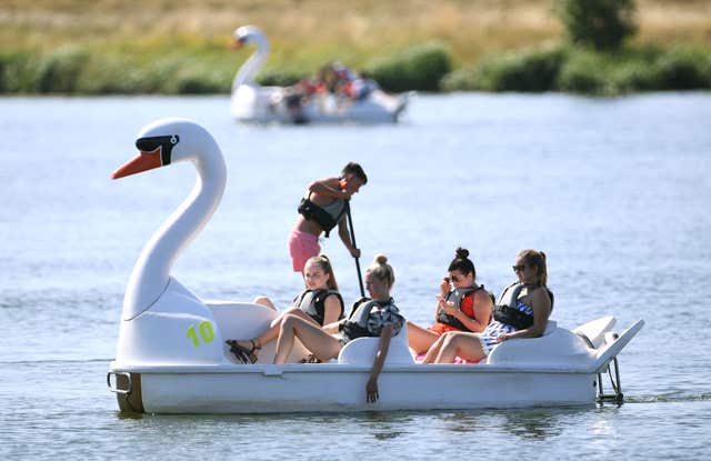 People on pedalos and paddleboards at Nene Park in Peterborough