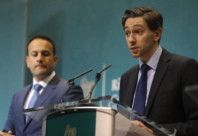 Mr Varadkar watches as Mr Harris speaks at a press conference (Lorraine O'Sullivan/PA)