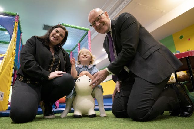 First Minister John Swinney and SNP candidate Katy Loudon with Grace Ure, aged two, during a visit to Juniors Charity in Hamilton