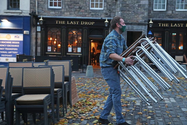 Man stacking chairs