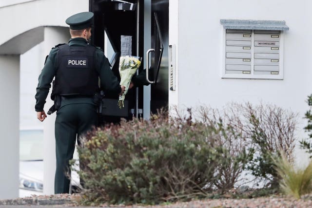 A police officer was handed flowers at the scene