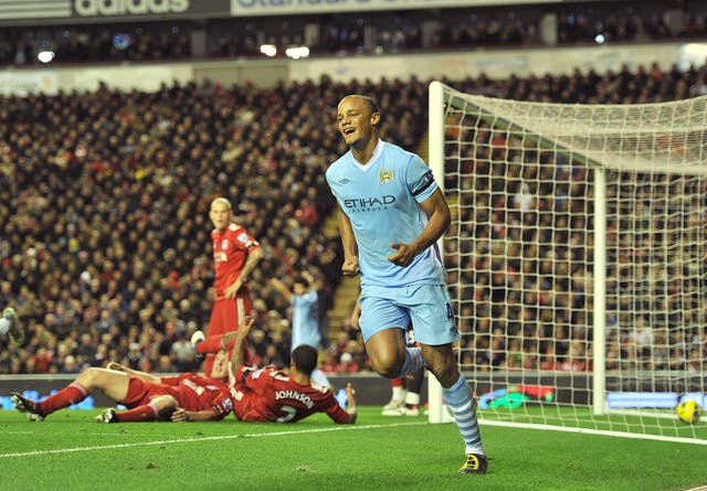 Vincent Kompany celebrates scoring at Anfield in November 2011. City were crowned champions the following May