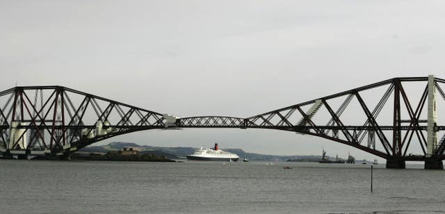 The QE2 moors in the River Forth beside the Forth Rail Bridge, again in 2007 (Andrew Milligan/PA)