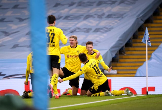 Marco Reus, right, and Erling Haaland, centre, celebrate with team-mates after Dortmund''s equaliser