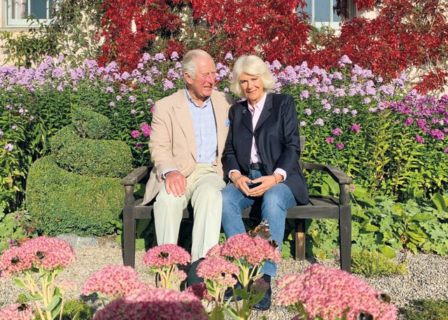 Charles and Camilla, pictured in a garden at Birkhall, will spend Christmas at their Gloucestershire home. The Prince of Wales and The Duchess of Cornwall/Clarence House
