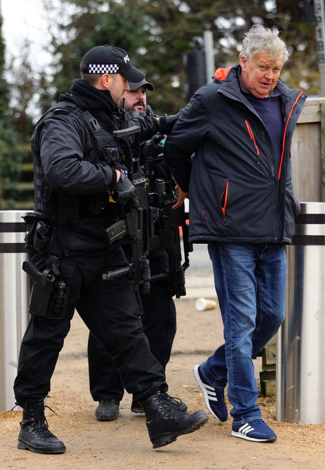 Harry Hicks is led away by armed police following his arrest during Ladies Day (Aaron Chown/PA).