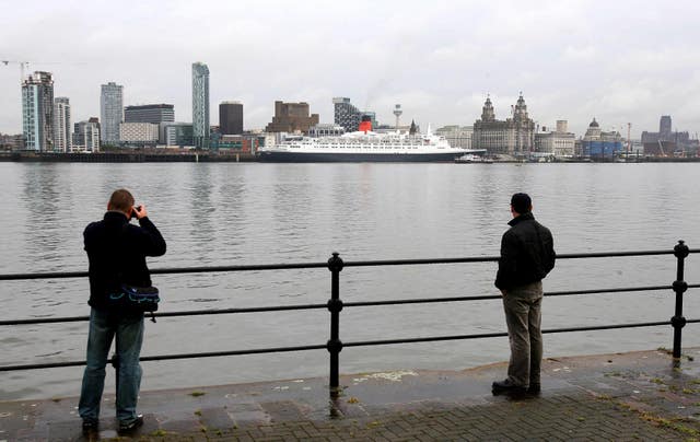 The QE2 sits docked on the River Mersey in Liverpool in 2007 (Martin Rickett/PA)