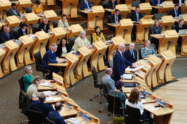 View of the Scottish Parliament debating chamber, with John Swinney standing while speaking